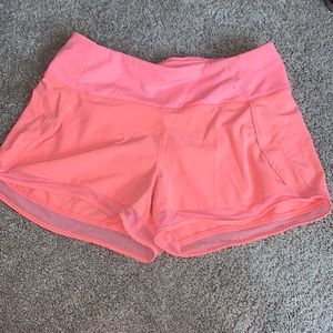 bright pink athletic shorts with mesh at the bottom